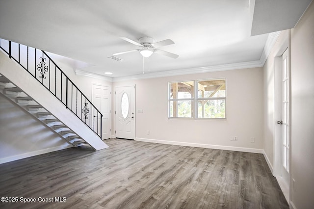 entrance foyer with hardwood / wood-style flooring, ceiling fan, and ornamental molding