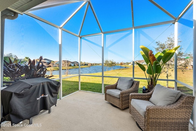 exterior space featuring a lanai, area for grilling, and a water view