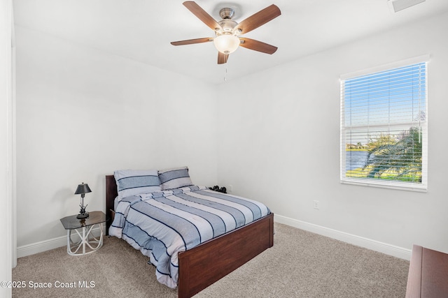 bedroom featuring ceiling fan and carpet