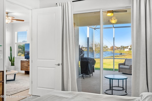 bedroom featuring a water view and access to outside