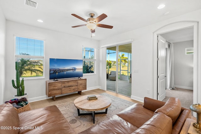 living room with ceiling fan and a healthy amount of sunlight