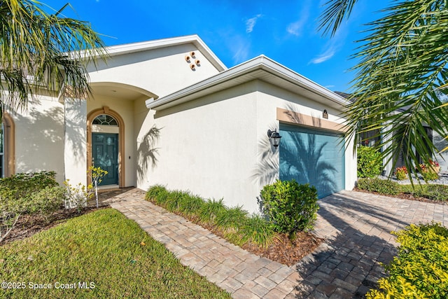 doorway to property with a garage