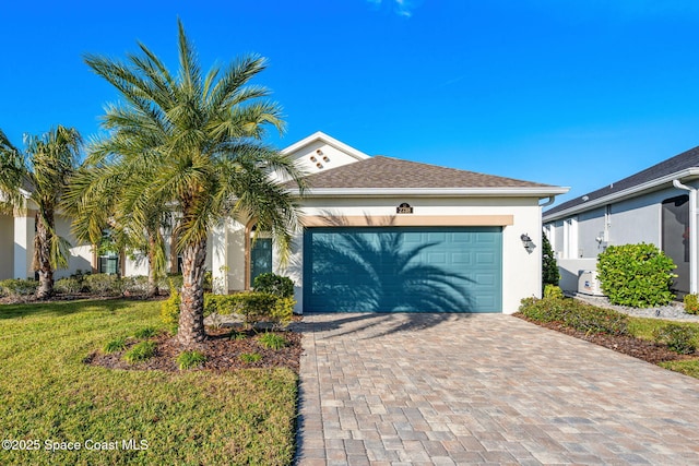 view of front of property with a front yard and a garage