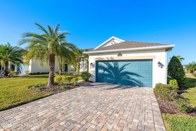 view of front of property with a garage and a front lawn