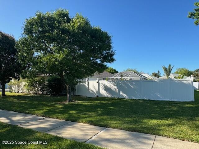 view of side of property with a lawn