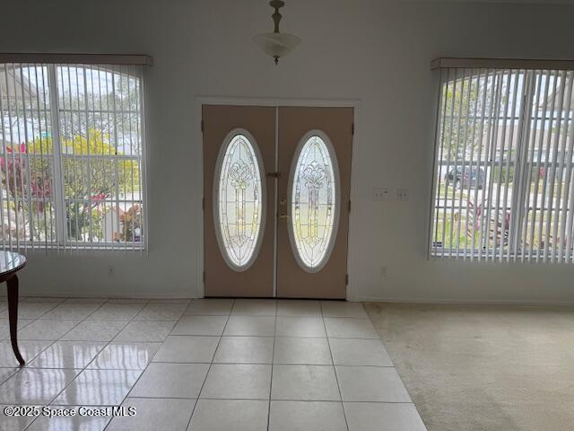 tiled entrance foyer with french doors