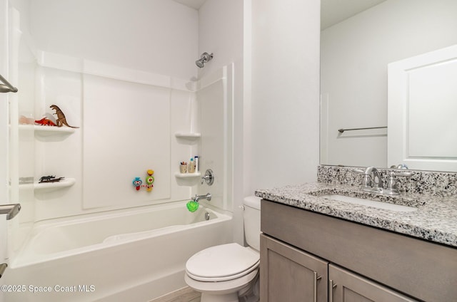 full bathroom featuring toilet, vanity, and tub / shower combination