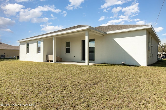 rear view of house with a patio area and a yard