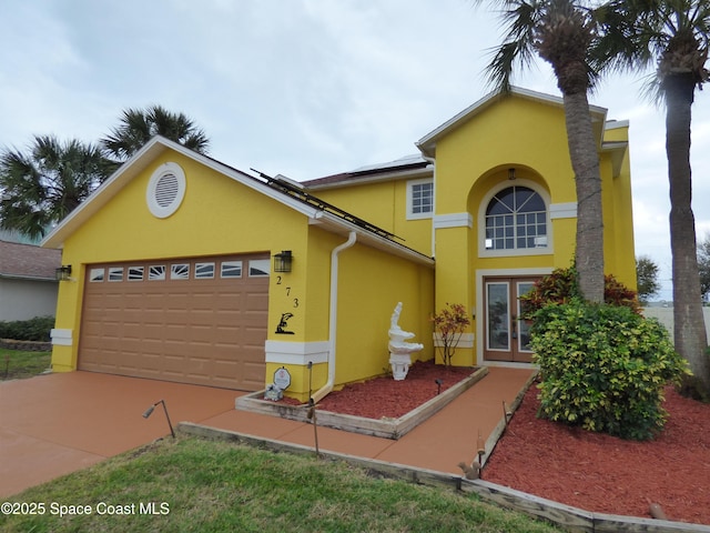 front of property with solar panels and a garage