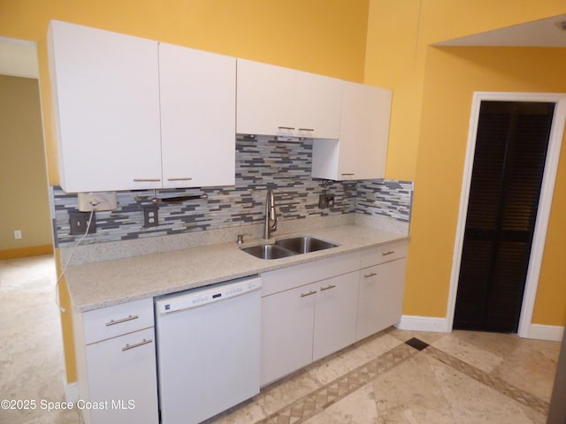 kitchen featuring white dishwasher, white cabinets, and sink