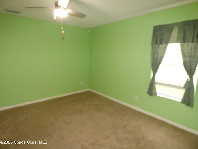 spare room featuring carpet flooring and ceiling fan