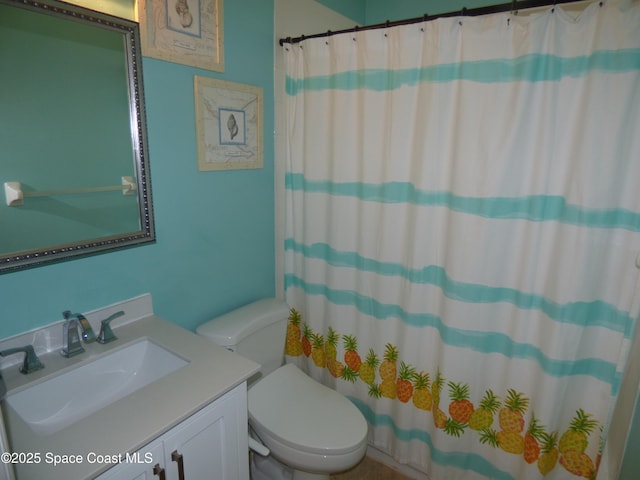 bathroom featuring vanity, toilet, and walk in shower