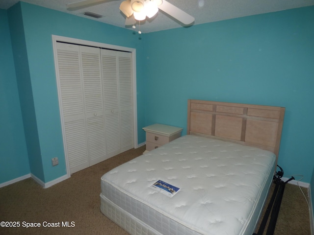 carpeted bedroom featuring ceiling fan and a closet