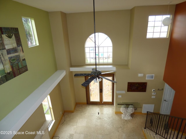 interior space featuring ceiling fan, french doors, and a healthy amount of sunlight