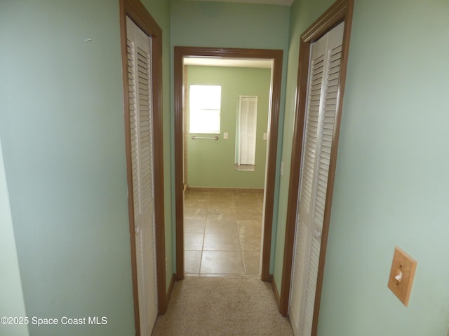 hallway with light tile patterned floors