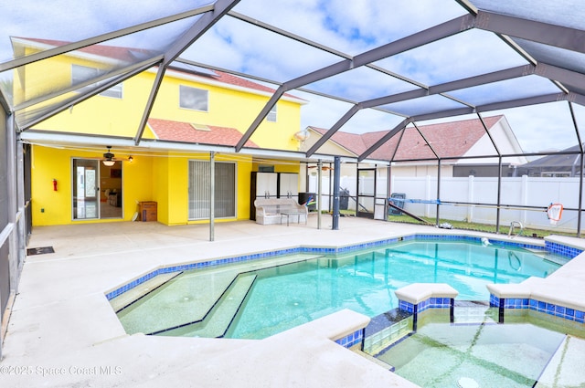 view of pool featuring ceiling fan, a patio area, a lanai, and an in ground hot tub