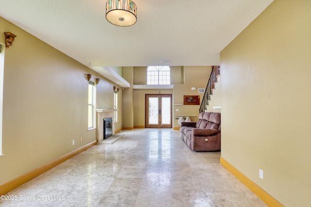 entryway featuring french doors and a textured ceiling