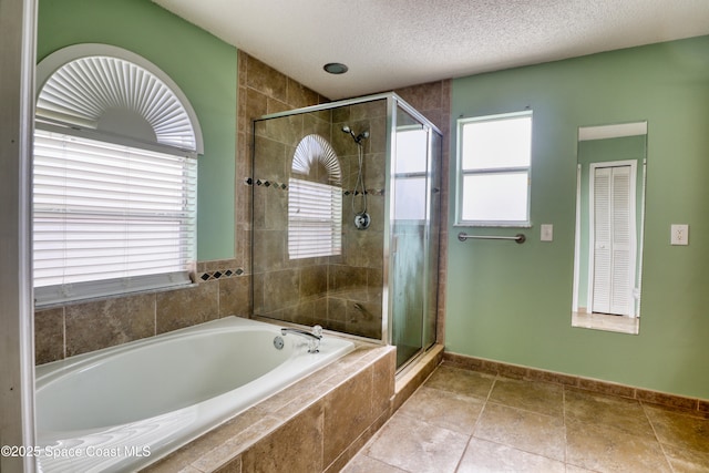 bathroom with a textured ceiling and plus walk in shower