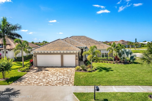 view of front of home with a garage and a front lawn