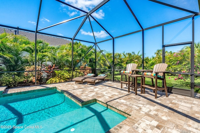 view of pool featuring a patio area and glass enclosure