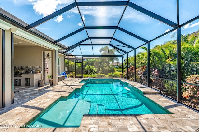 view of swimming pool with a patio area, area for grilling, and a lanai