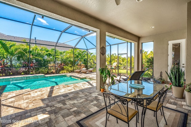 view of pool with a lanai and a patio