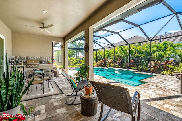 view of swimming pool featuring grilling area, exterior kitchen, ceiling fan, a lanai, and a patio