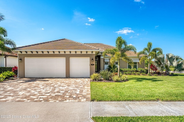 view of front of property with a front yard and a garage