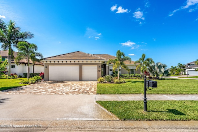 view of front of property featuring a front yard and a garage