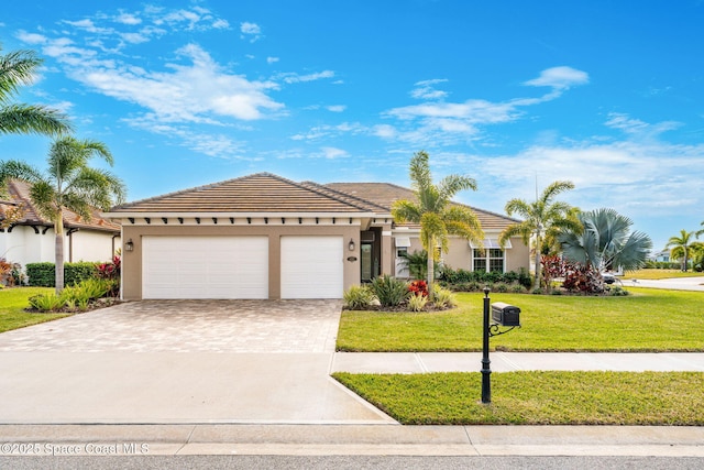 view of front of house featuring a front lawn and a garage