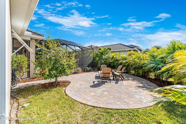 view of patio featuring glass enclosure