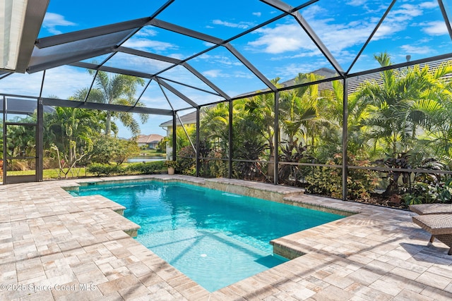 view of pool with a lanai and a patio area