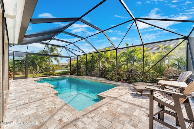 view of pool featuring a lanai and a patio