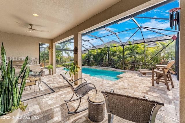 view of pool featuring a lanai, ceiling fan, and a patio