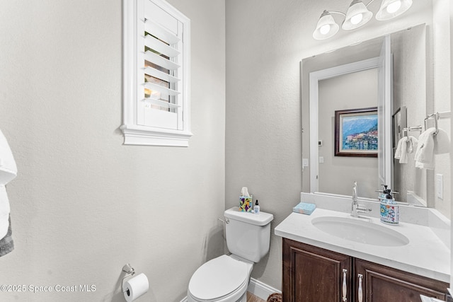 bathroom featuring toilet and vanity