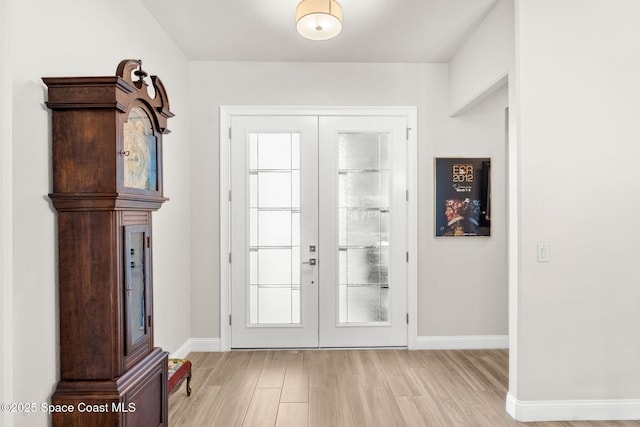 doorway with french doors and light hardwood / wood-style flooring