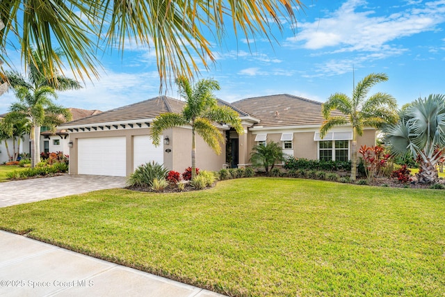 view of front facade with a front yard and a garage