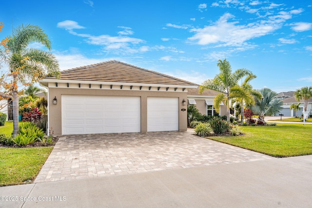 view of front of home with a front yard and a garage