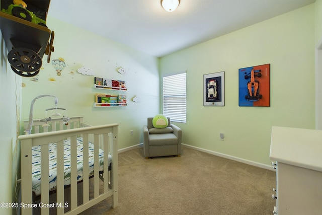 bedroom with a crib and carpet floors