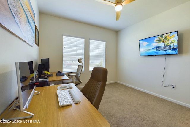 carpeted home office featuring ceiling fan