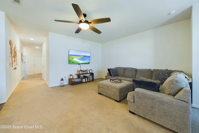 carpeted living room with ceiling fan