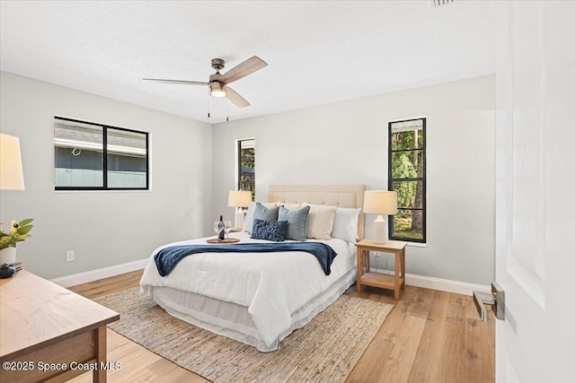 501 Empire Ave NE, Palm Bay, FL 32907 - bedroom with ceiling fan, a textured ceiling, and light wood-type flooring
