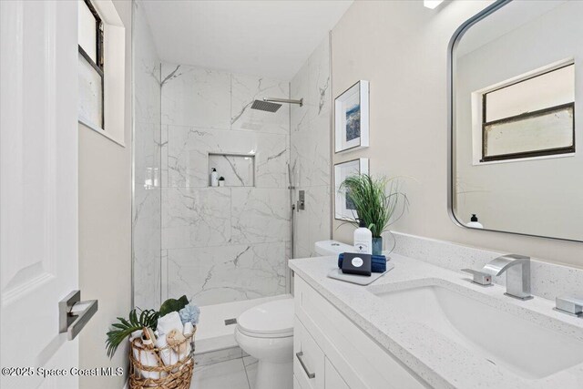 501 Empire Ave NE, Palm Bay, FL 32907 - bathroom with tiled shower, vanity, and toilet