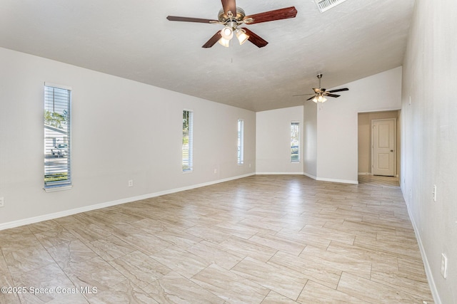 spare room featuring ceiling fan and vaulted ceiling