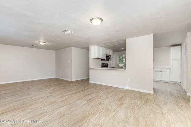 unfurnished living room with a textured ceiling