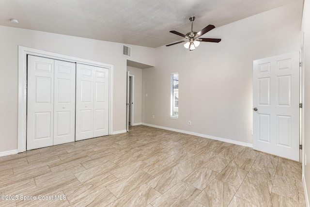 unfurnished bedroom featuring ceiling fan, a closet, and vaulted ceiling