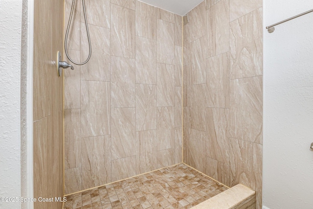 bathroom with tiled shower