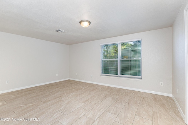 spare room featuring a textured ceiling