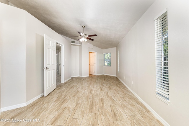 unfurnished bedroom featuring ceiling fan, light hardwood / wood-style floors, and lofted ceiling