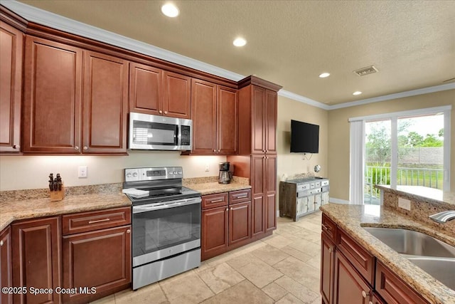 kitchen with crown molding, appliances with stainless steel finishes, a textured ceiling, sink, and light stone counters